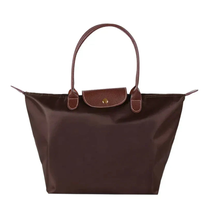 Braune Damenhandtasche aus Leder und Nylon, elegant, geräumig, mit Tragegriffen.